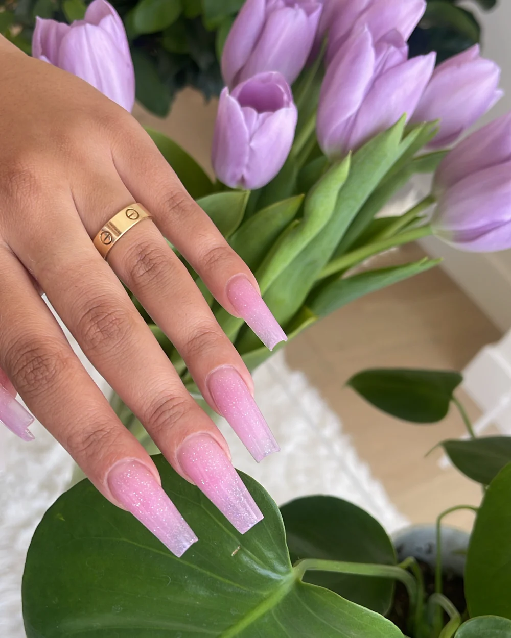 Soft pink glitter nail extensions with purple tulips